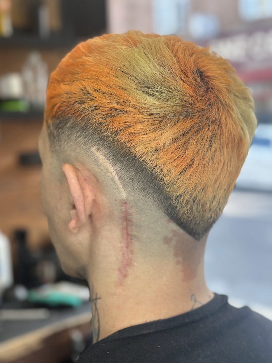 A bold orange hair colour on a textured crop with a low fade, coloured at The Clip Joint Hackney